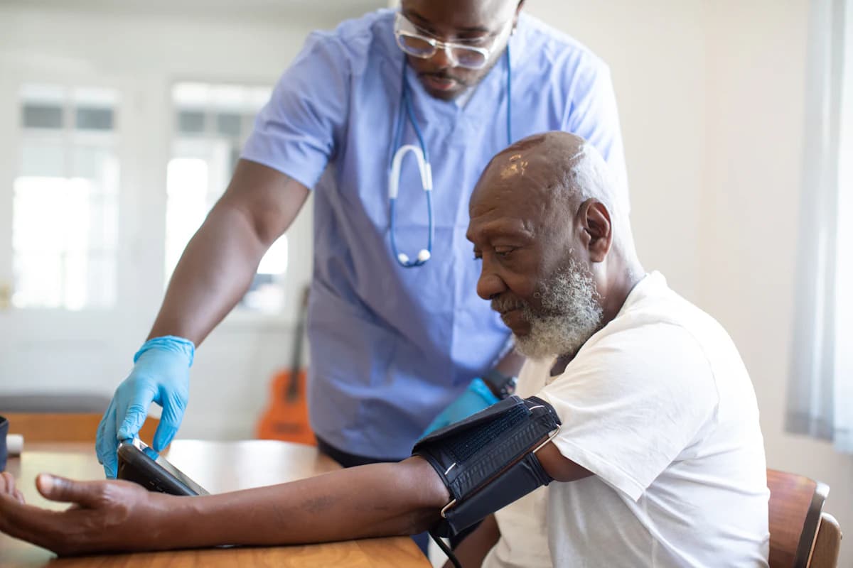 Home health nurse taking an older patient's blood pressure