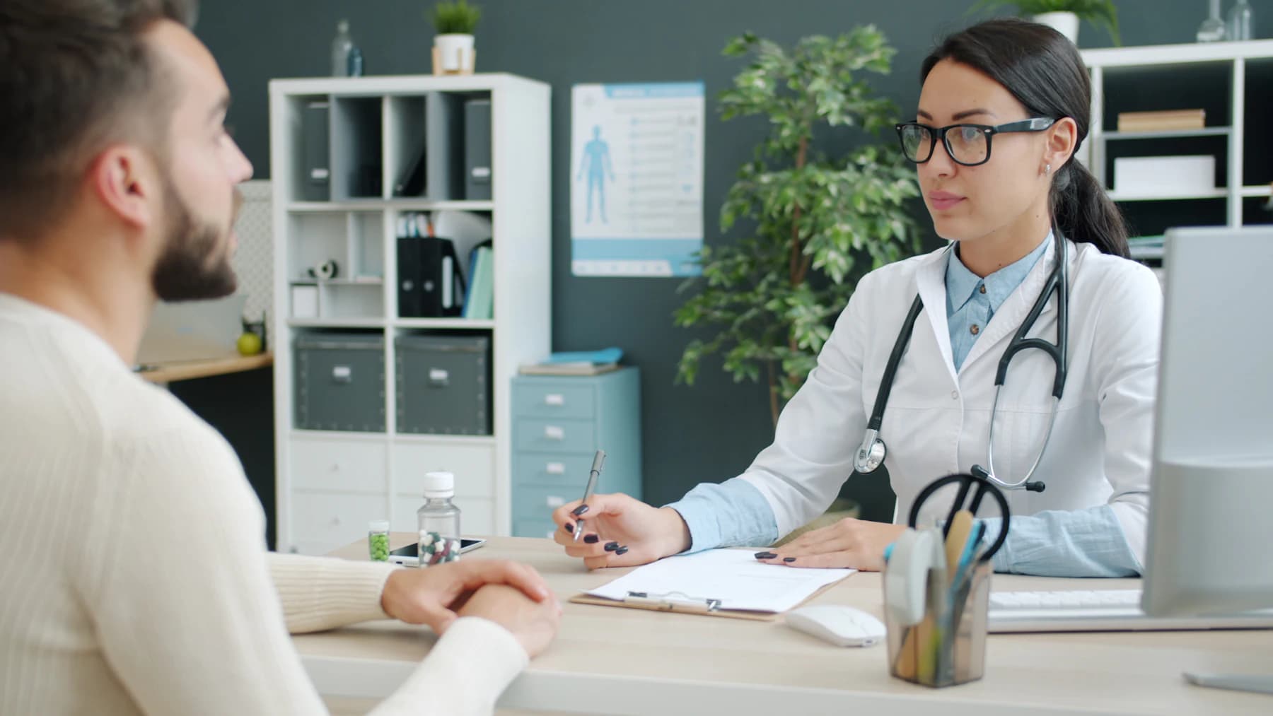 Physician consulting with a patient in her office