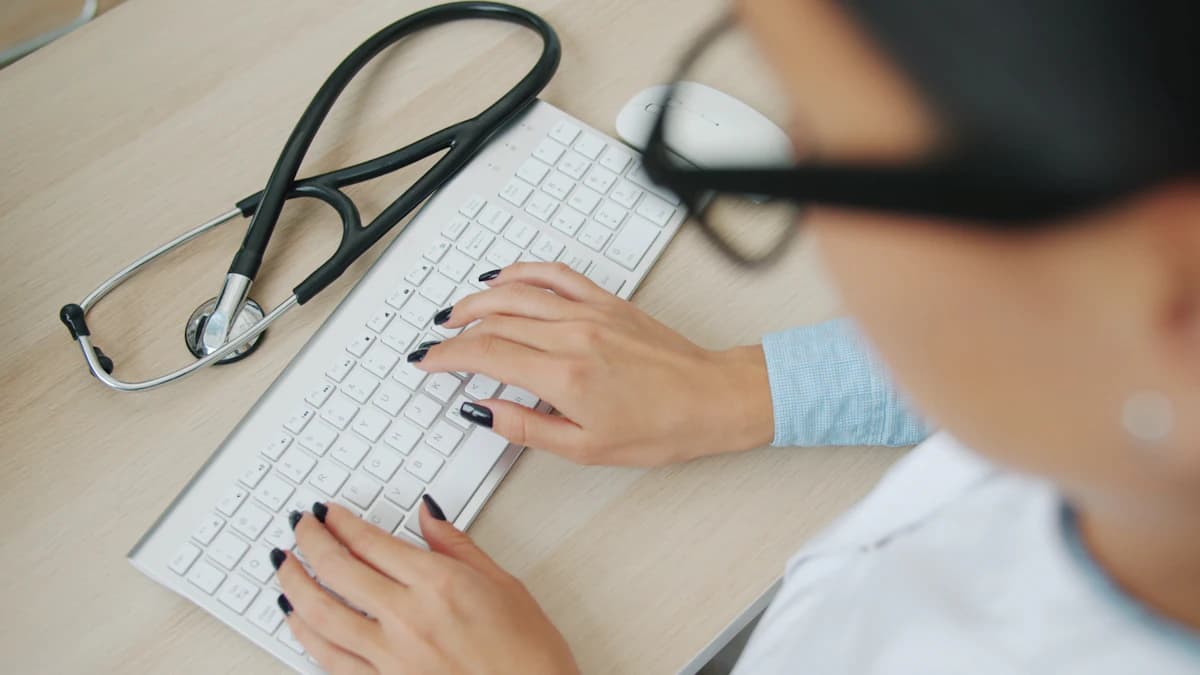 Billing specialist entering charges at a keyboard