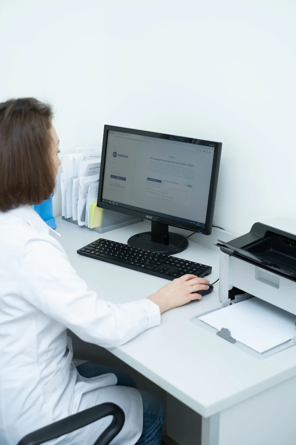 Specialist working claims at a computer workstation