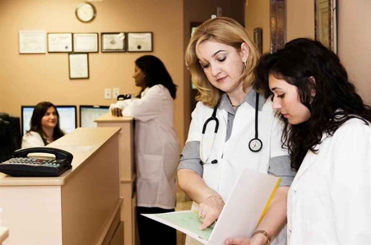 Front desk staff reviewing a patient's insurance paperwork