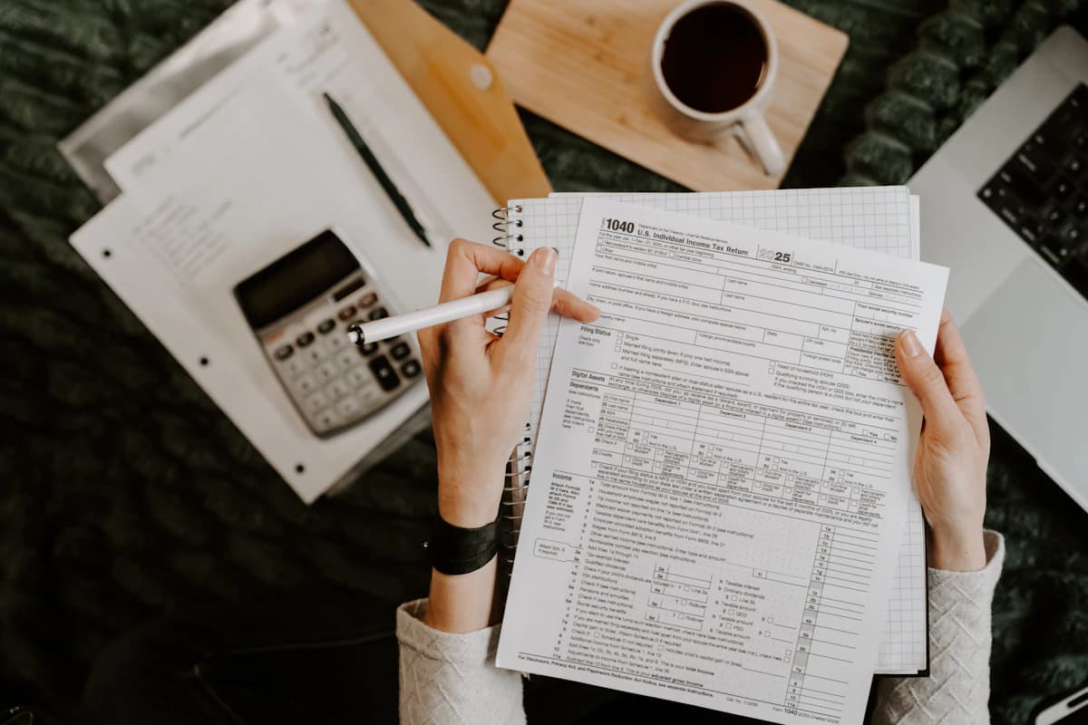 Billing specialist working through charge documents with a calculator